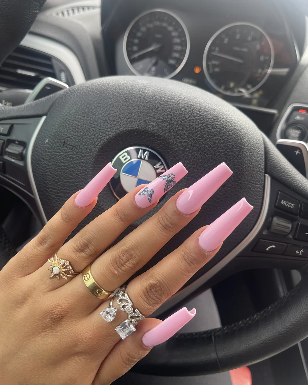 Pink butterfly nail extensions photographed from the client portfolio
